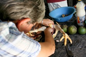 Lucy prepares a chicken for soup. 